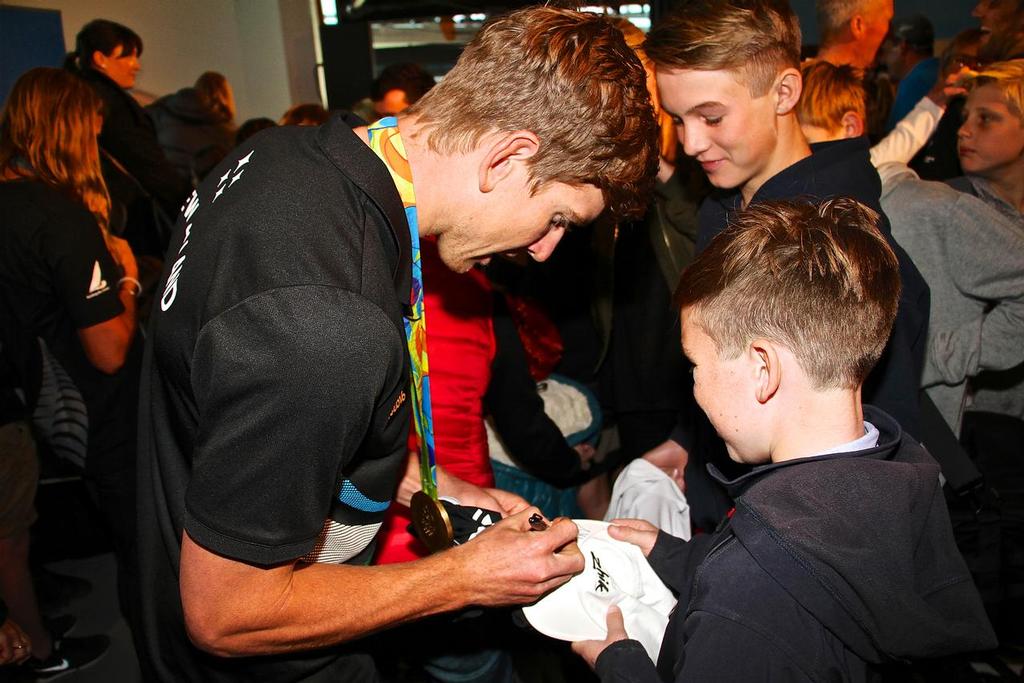 Peter Burling signs a Zhik hat for a young fan - Olympics 2016 - Day 12 - Auckland - NZ Sailors return home - August 24, 2016 © Richard Gladwell www.photosport.co.nz